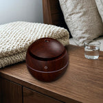 Mushroom humidifier on a desk, deep wood grain
